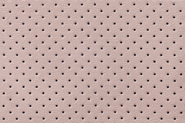 Photo perforated beige leather texture background,  light brown backdrop from wrinkle skin,