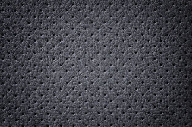 Perforated dark gray leather texture background