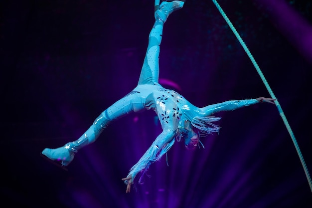 Photo performance of an aerial gymnast in a circus in front of the audience