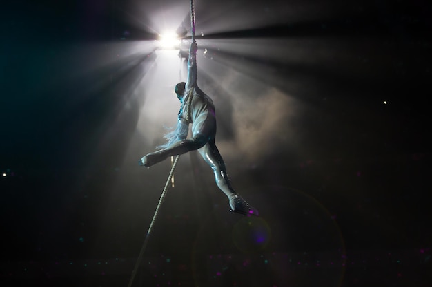 Photo performance of an aerial gymnast in a circus in front of the audience