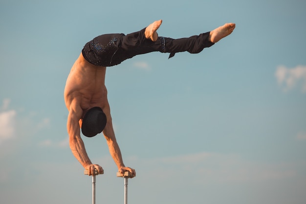 Performance of an aerialist outdoors during sunset.