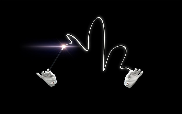 перформанс, иллюзия, цирк, концепция шоу - руки фокусника в перчатках со светящейся волшебной палочкой, показывающей трюк на черном фоне