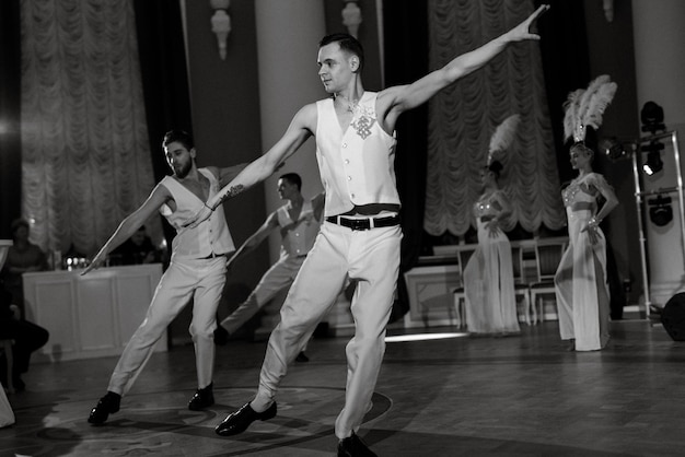 Performance of a showballet of a dance group of actors in bright costumes