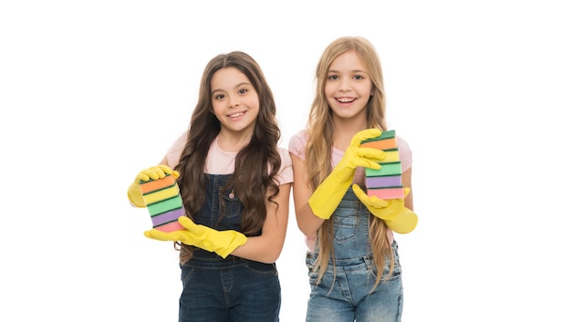 Performing household duties Small housekeepers holding dish sponges in rubber gloves Little housemaids ready for household help Adorable kitchen maids doing household activity Household duties