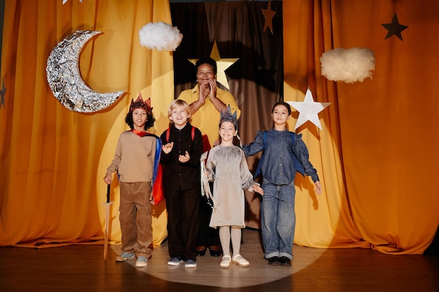 performing school play with children on stage grinning