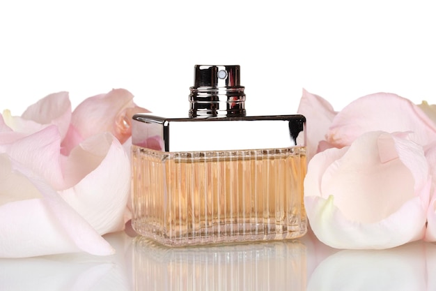 Perfume in a beautiful bottle and petals isolated on white