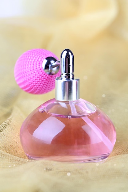 Perfume bottle on fabric background