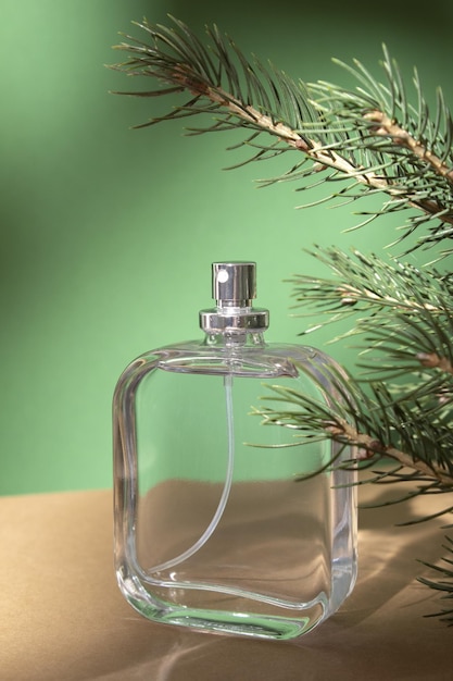 Perfume bottle and fir branches Concept of expensive perfume and cosmetics Floral fragrance