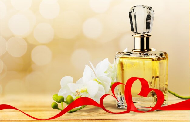 Photo perfume bottle and flowers isolated on  background.