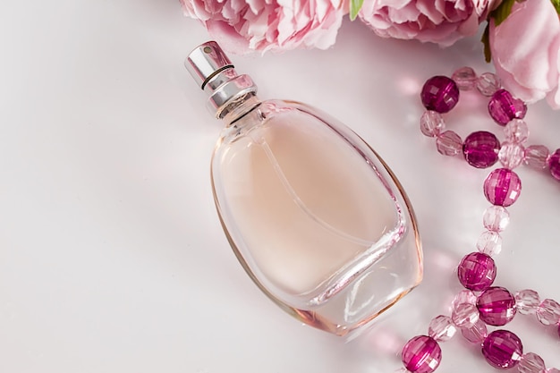 perfume bottle and flowers on a white background gift concept for womens day