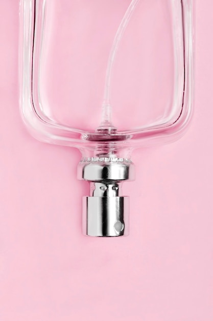 Perfume bottle on pink