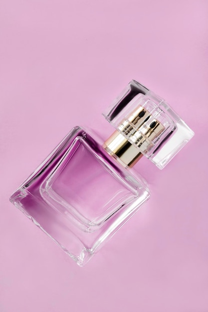 Perfume bottle on pink