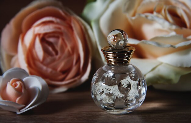 Perfume bottle and roses. Retro style.