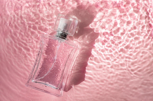 Perfume bottle on the surface and water drops. A bottle of perfume without inscriptions .