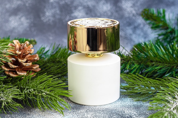 Perfume bottle surrounded by Christmas tree branches