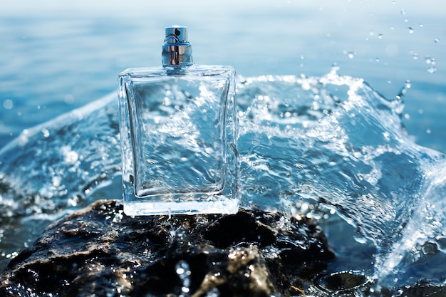 Perfume bottle in water splashes