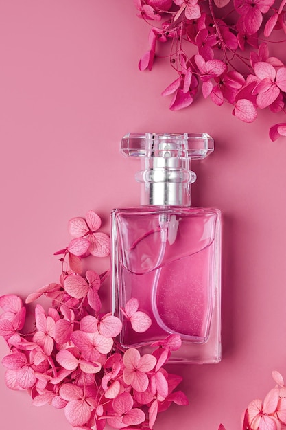 Premium Photo | Perfume bottle with pink flowers on pastel background ...