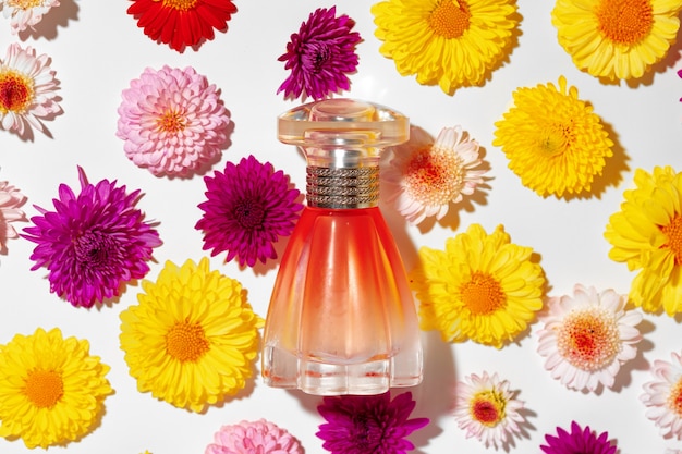 Perfume bottle for women in flower buds close up