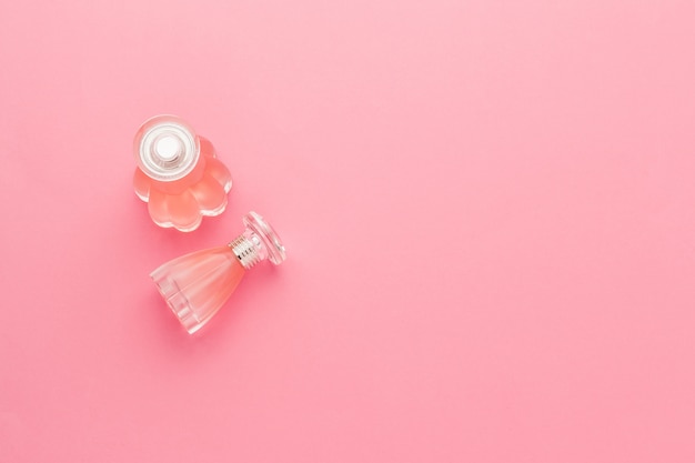 Perfume bottles on pink