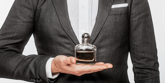 Perfume or cologne bottle and perfumery cosmetics scent cologne bottle male holding cologne Masculine perfume Male holding up bottle of perfume Man perfume fragrance