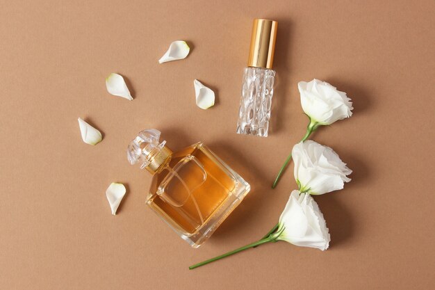 Perfume and flowers on a colored background