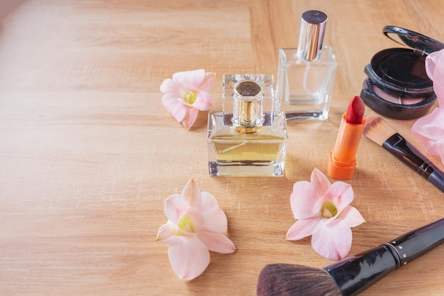 Perfume  and makeup cosmetics on wooden  background