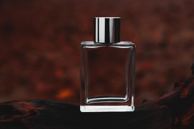 Perfume on a red natural surface