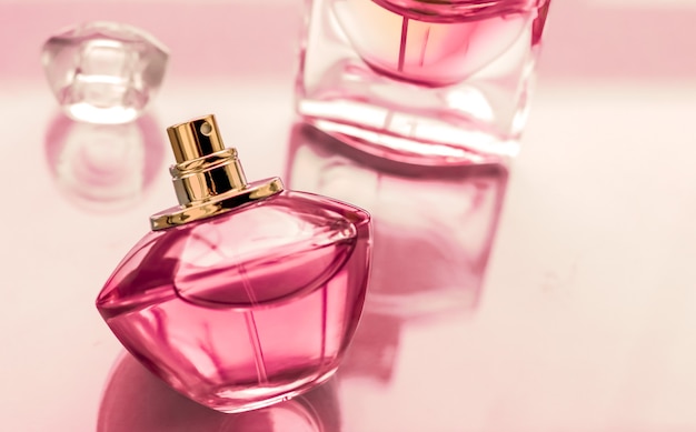 Perfumery spa and branding concept  pink perfume bottle on glossy background sweet floral scent glamour fragrance and eau de parfum as holiday gift and luxury beauty cosmetics brand design