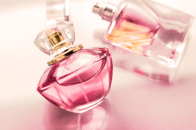 Perfumery spa and branding concept  pink perfume bottle on glossy background sweet floral scent glamour fragrance and eau de parfum as holiday gift and luxury beauty cosmetics brand design