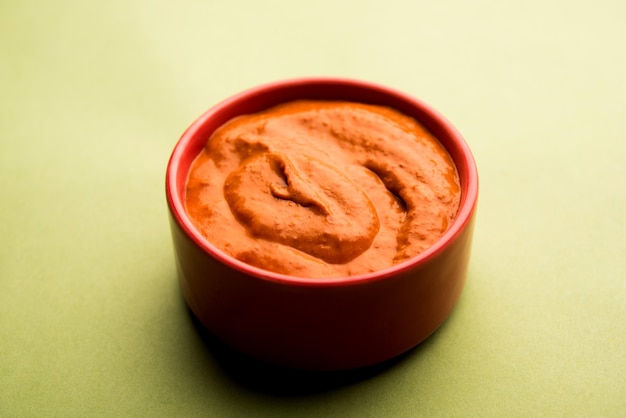 Peri Peri Sauce in a bowl, originally from portugal, it's a hot sauce made using piri piri or African bird's eye chillies.  selective focus