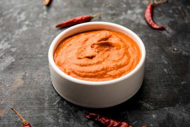 Peri Peri Sauce in a bowl, originally from portugal, it's a hot sauce made using piri piri or African bird's eye chillies.  selective focus