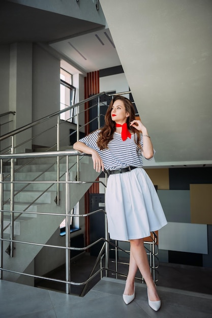 A perky girl in a striped Tshirt with a red tie 4161