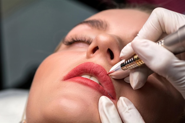 Permanent make up procedure. lip makeup in tattoo salon.