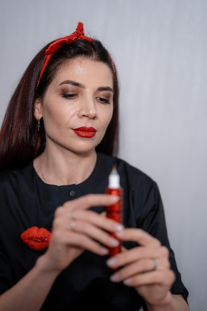 Permanent makeup teacher examining her tool for permanent makeup at the studio Eyebrow master or make up artist at work