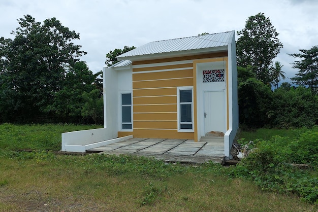 A permanent white house with a small garage in the morning