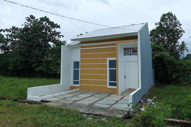 A permanent white house with a small garage in the morning