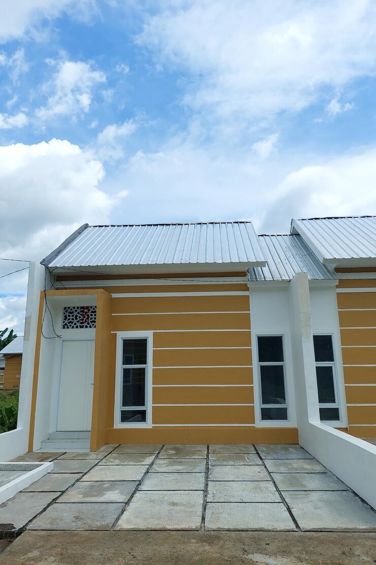 Permanent white houses are lined up with small garages in the morning