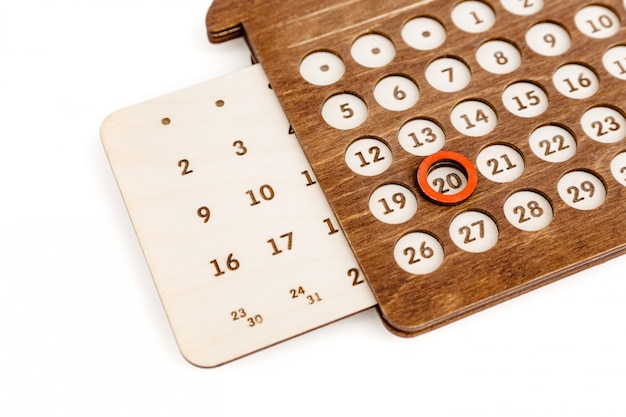 Perpetual wooden calendar in the shape of a house.