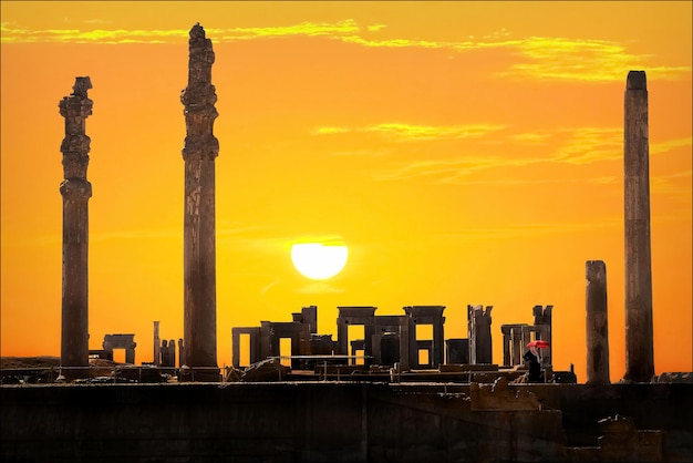 Persepolis is the capital of the ancient Achaemenid kingdom Ancient columns Sight of Iran Ancient Persia Orange sunset background Artistic image