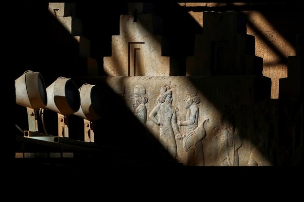 Persepolis is the capital of the ancient Achaemenid kingdom Sight of Iran Ancient Persia Basrelief carved on the walls of old buildings against the black background