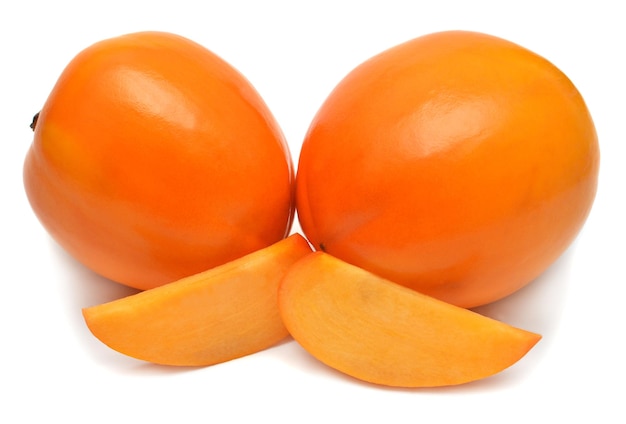 Persimmon fruit whole and slices isolated on a white background