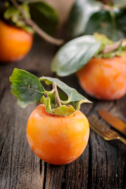 Persimmon fruit on wooden table