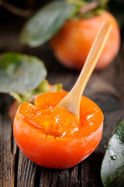 Persimmon fruit on wooden table