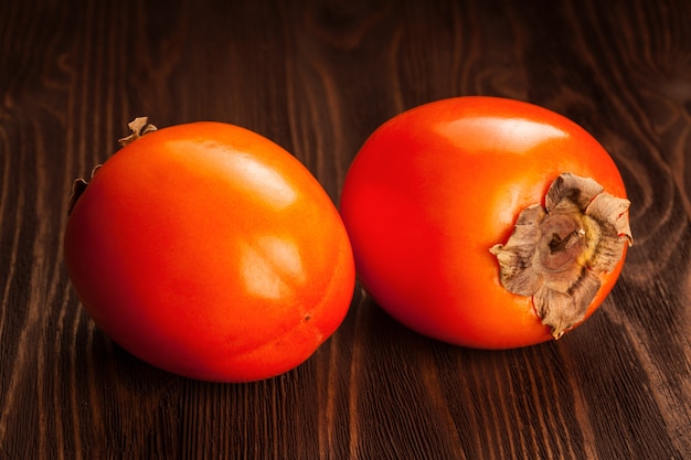 Persimmon on wooden table