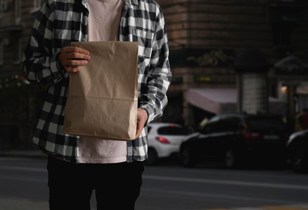 A person carrying paper package with delivered food