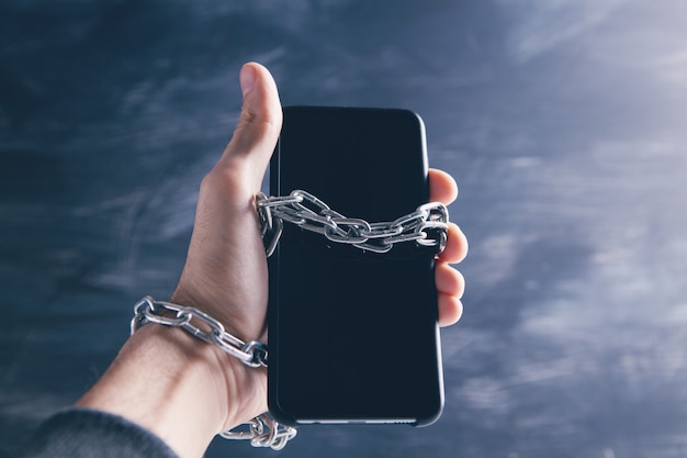 Person chained to a smartphone