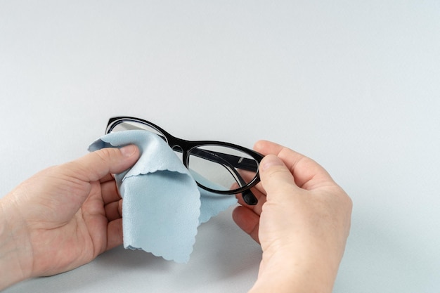 Person Cleaning Eyeglasses