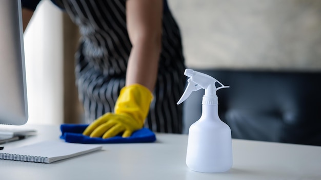 Person cleaning the room the cleaner is wiping the desk in the company office Cleaning staff Concept of cleanliness in the organization