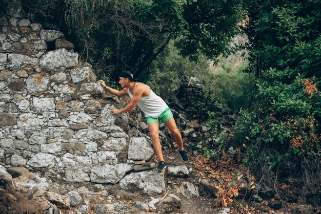 person climbing on a rock