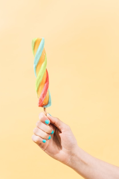 person clutching a multicolored ice cream